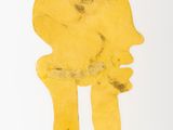 a close up of a gold object on a white surface