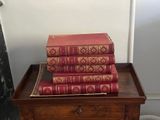 a stack of books sitting on top of a wooden table