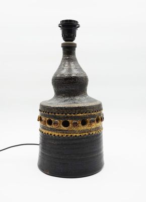 a black and gold vase with a black top
