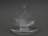 l'image d'un cygne en verre posé sur une assiette en verre