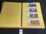 a yellow book with stamps on it on a table