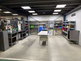 an image of a room with a lot of shelves and a table