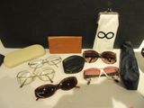 a table with sunglasses, a purse, and other items on it