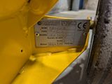 a close up of a yellow fire hydrant with a label on it