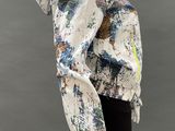 an image of a mannequin wearing a colorful jacket and black leggings