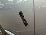 a sticker on the door of a silver car