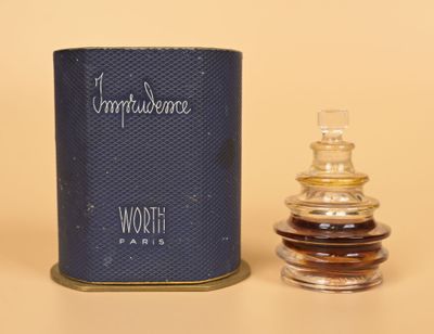 an image of a bottle of perfume next to a canister of perfume