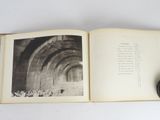 an open book with a black and white photo of a tunnel