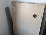 a wooden cabinet in the corner of a room