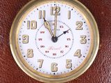 a clock that is sitting on a brown table
