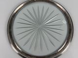 an image of a silver plate with a starburst design on it