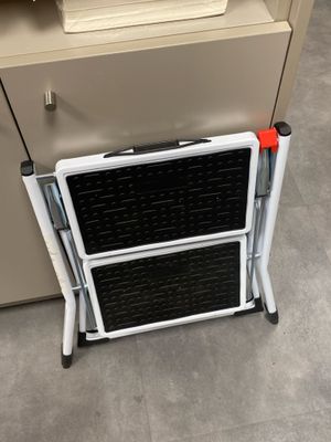 an image of a small folding chair next to a filing cabinet
