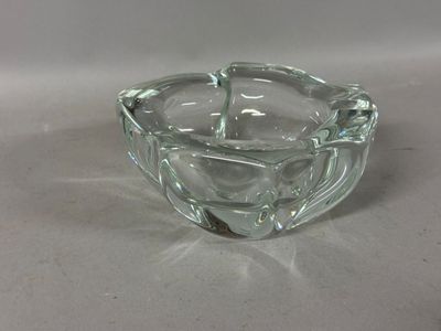 a clear glass ashtray with a silver handle