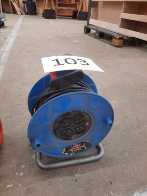 a blue hose sitting on the ground next to a red fire hydrant