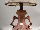 a lamp that is sitting on a table with a lamp shade on it