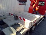 a truck with a crane on the back of it ' s bed