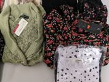 several pairs of sweaters are sitting on a table next to each other