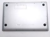 the back of a silver laptop computer sitting on top of a white table