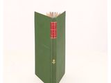 a green book with a red bookmark on top of it