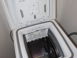a small white refrigerator that is open on the floor