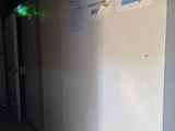 a white refrigerator with a blue arrow on it