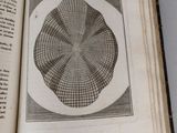 an open book with a drawing of a circle on it