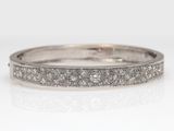 a close up of a diamond ring on a white surface