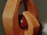 a wooden sculpture that is on a red surface