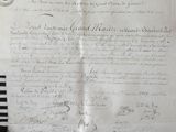 an old document with writing on it sitting on a table