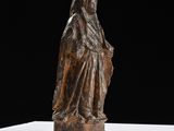 statue of a woman holding a child on a white surface