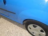 a blue car that is parked on the side of the road