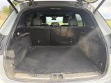 the back of a car with the trunk open and the seats folded down
