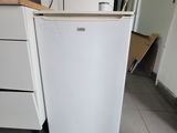 a white refrigerator sitting in a kitchen next to a counter
