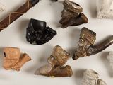 many different types of carved objects on a white surface