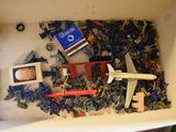 a box full of toy airplanes and other items