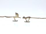 three figurines of a horse and a dog on a white surface