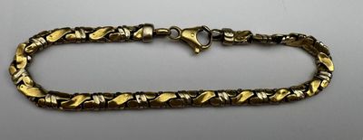 a close up of a bracelet on a table with a white background
