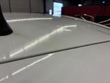 a close up view of the hood of a white car