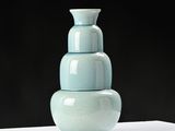 a blue vase sitting on top of a white table