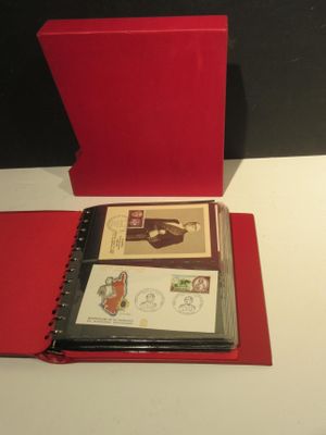 un classeur rouge orné de timbres, posé sur une table