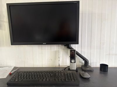 a computer monitor and keyboard on a desk with a mouse