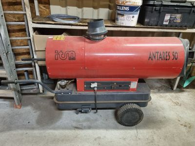 a red propane gas heater sitting in a garage