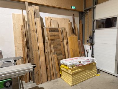 many pieces of wood stacked on top of each other in a room
