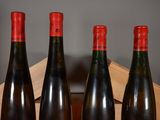 three bottles of wine are lined up in a row on a table