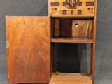 a small wooden cabinet with a small shelf on top of it