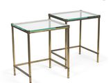 a pair of brass and glass side tables