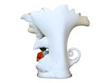 a white vase with a figurine of a man and a woman on it