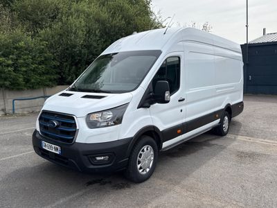 La camionnette blanche est garée sur le parking près des arbres.