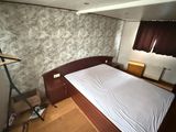 a bed that is in a small room with a wooden floor