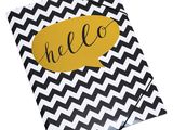 a black and white chevroned notebook with the word hello on it